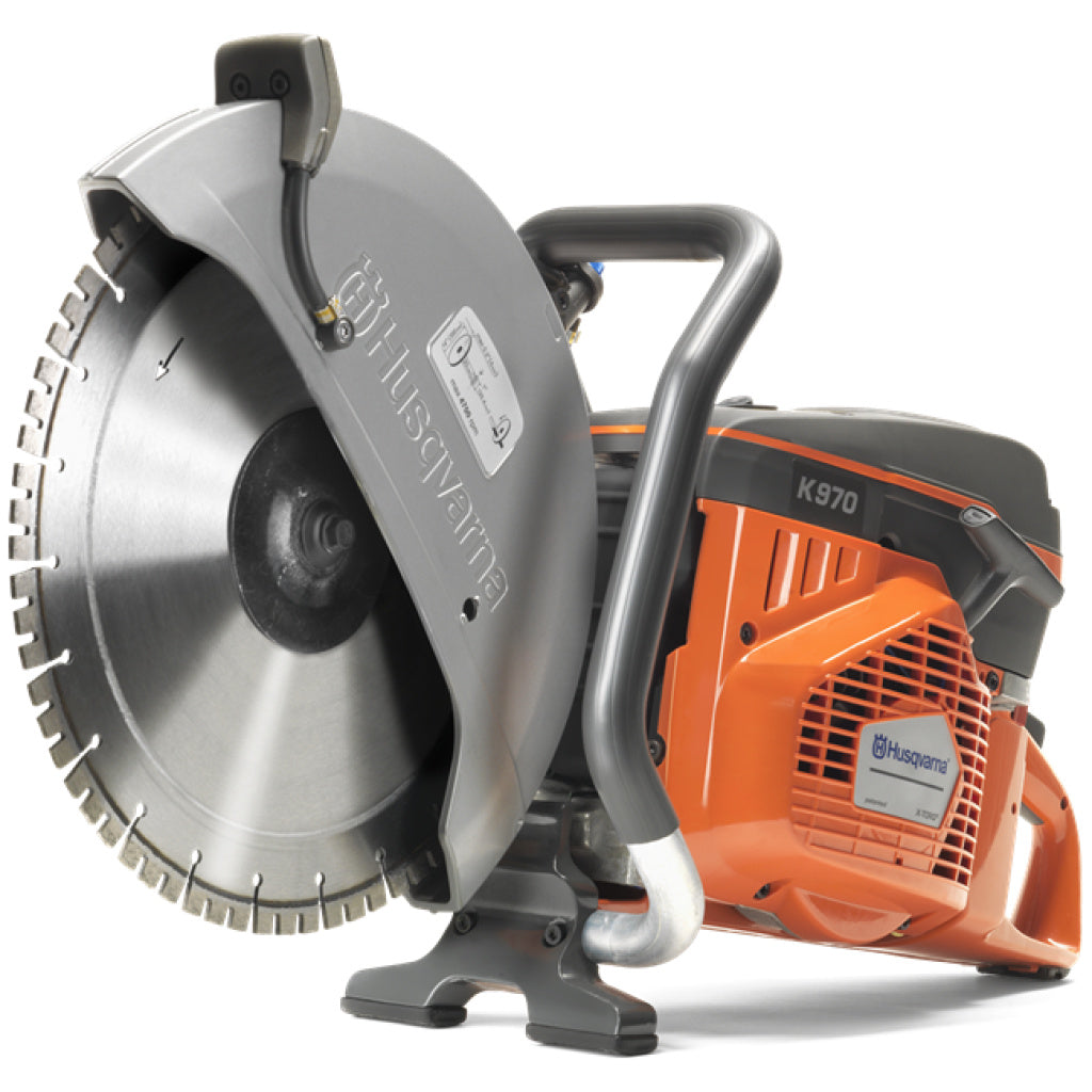 Husqvarna K970 circular saw with a large silver diamond blade, protective guard, orange engine housing, and black handle on a white background.