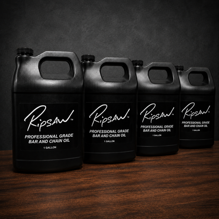 Four black 1-gallon jugs of Ripsaw Professional Grade Bar and Chain Oil arranged in a row on a dark wooden surface against a dark gray background.