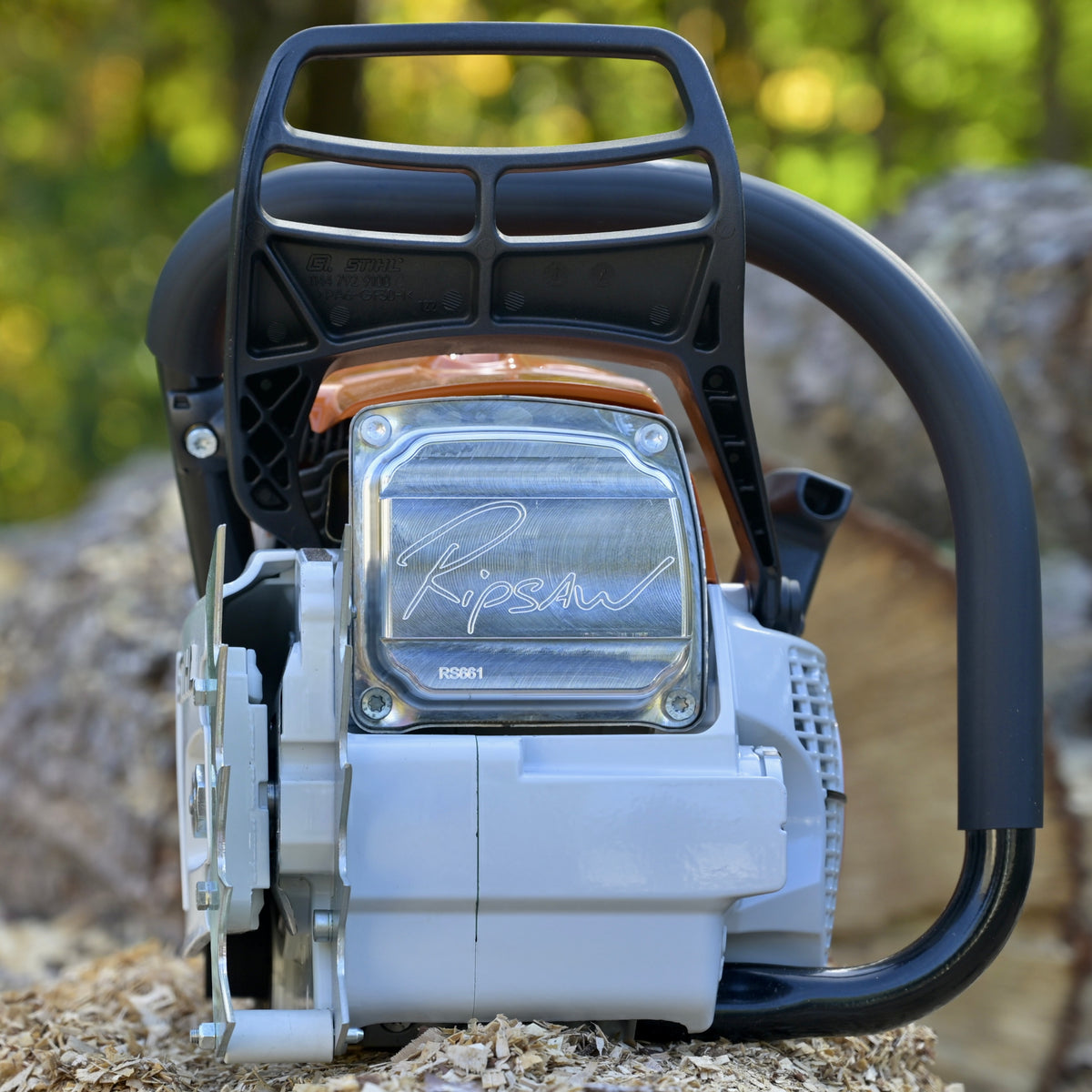 Close-up of a chainsaw with 'Ripsaw' branding against a blurred natural background.