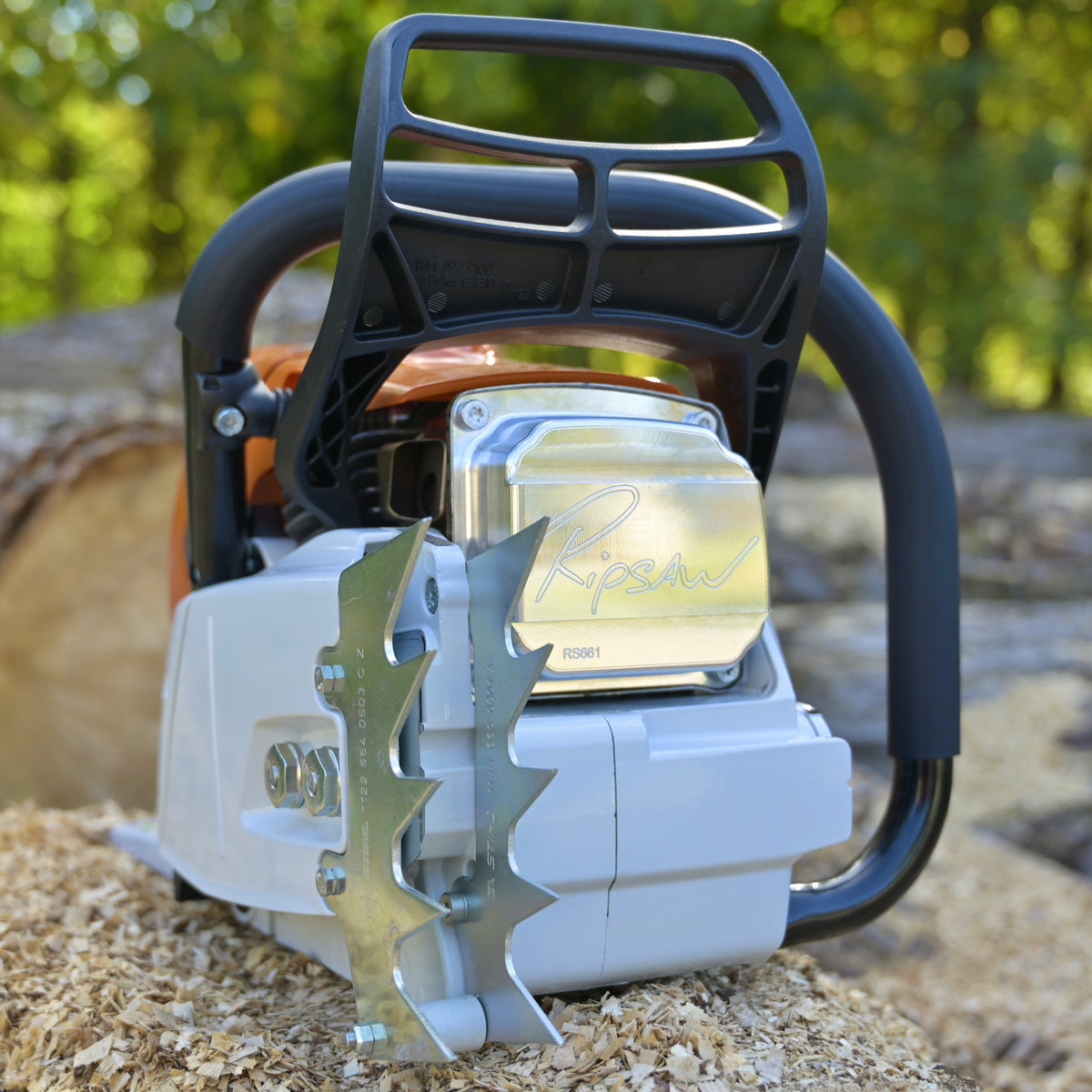Close-up of a chainsaw with a blurred natural background