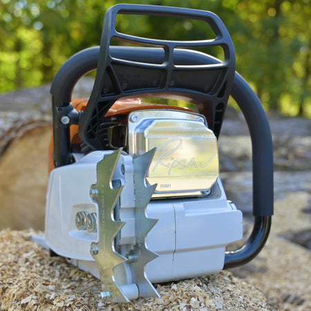 Close-up of a chainsaw with a blurred natural background