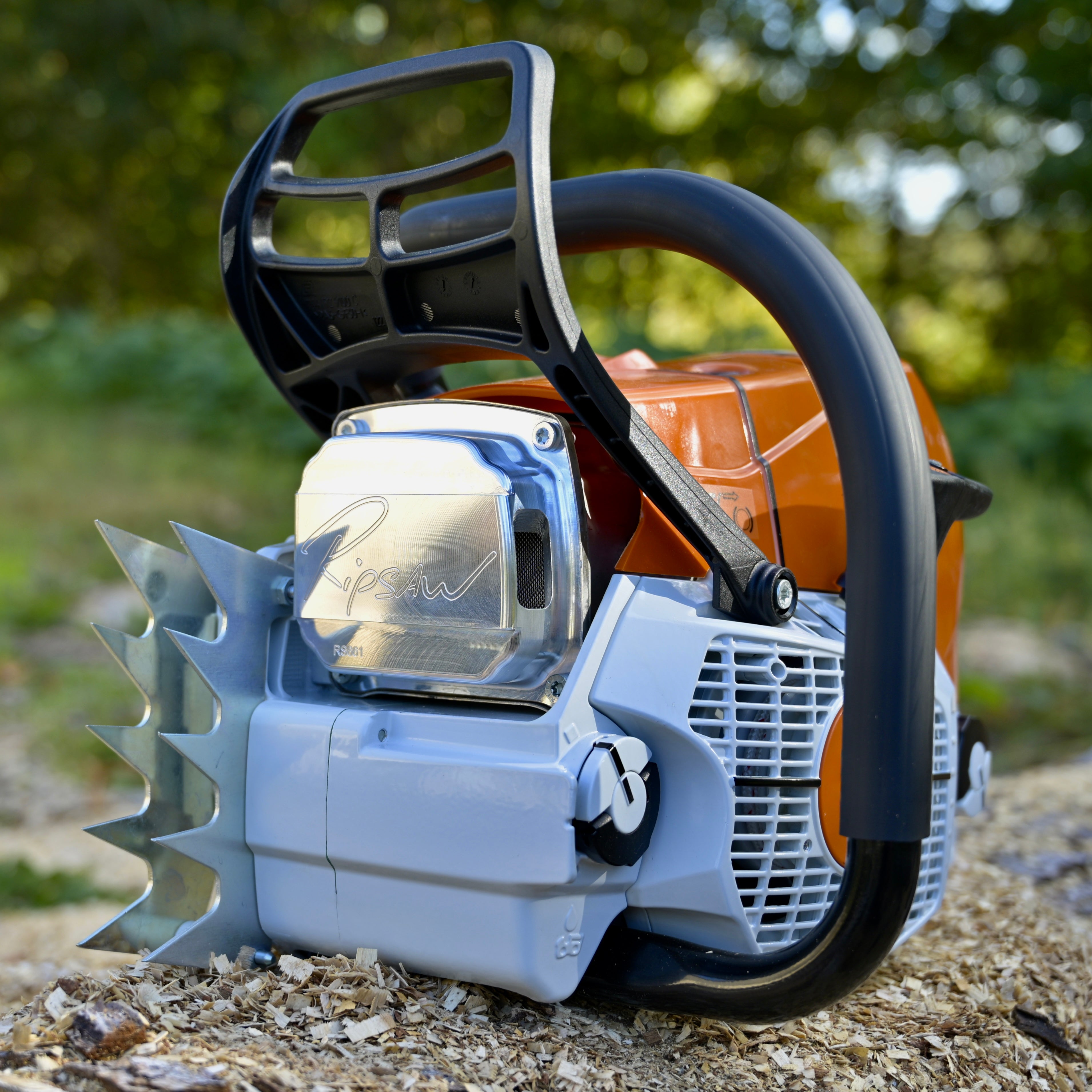 Close-up of a chainsaw with a blurred natural background