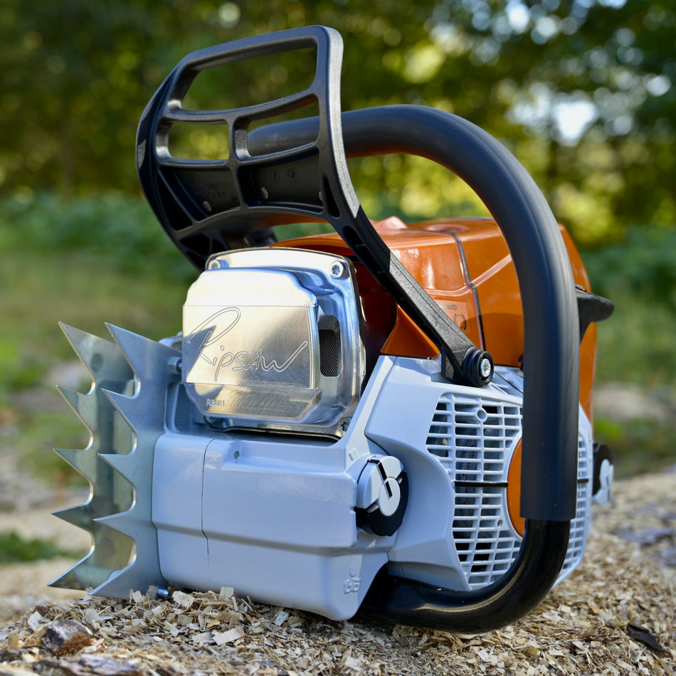 Close-up of a chainsaw with a blurred natural background